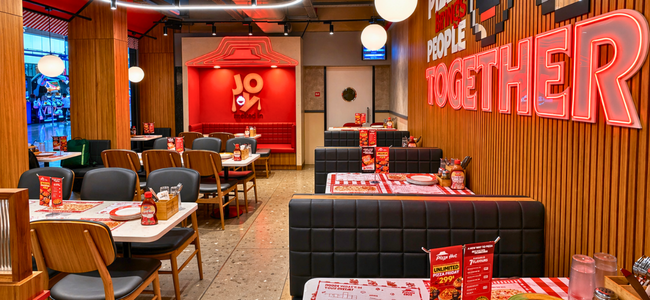 Finished quick-service restaurant interior with branded booth seating, ready for a multi-location chain rollout